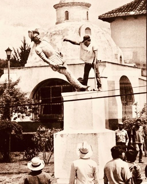 An indigenous man knocks over a statue of a Spanish conquistador on the 500th anniversary of the European discovery of the Americas, Chiapas, Mexico, 1992
